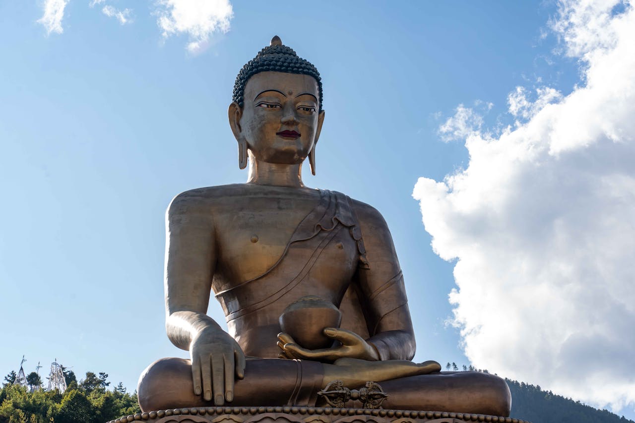 get-in-touch Majestic Buddha Dordenma statue against a serene sky in Thimphu, Bhutan.