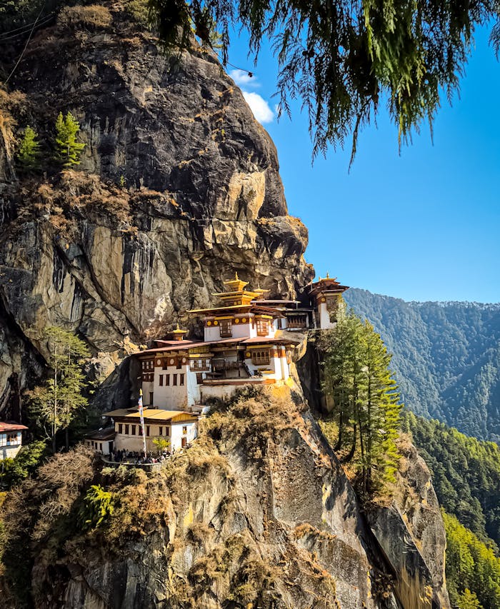Capture of the iconic Tiger's Nest Monastery perched on a cliff in Paro, Bhutan, under a clear blue sky.